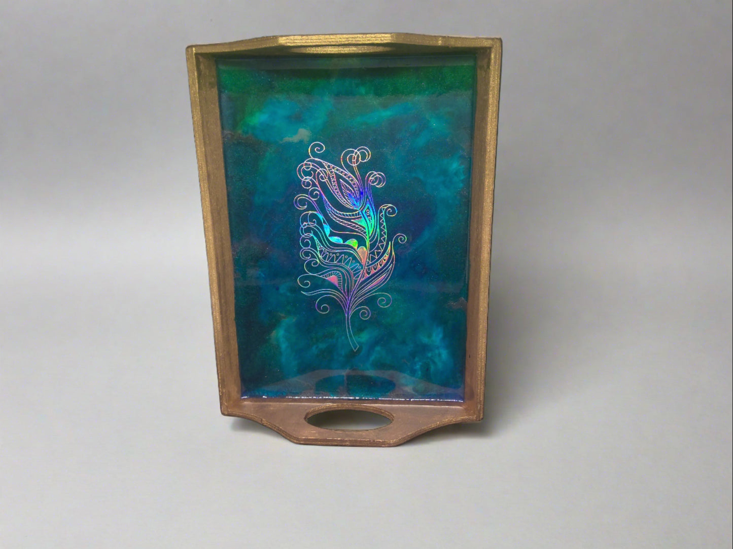 small gold tray with feather