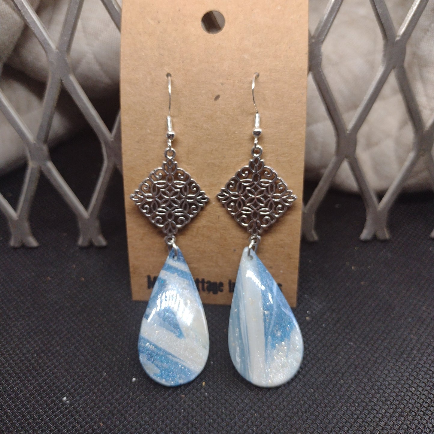 Blue and sparkling swirls with silver rhombus flower