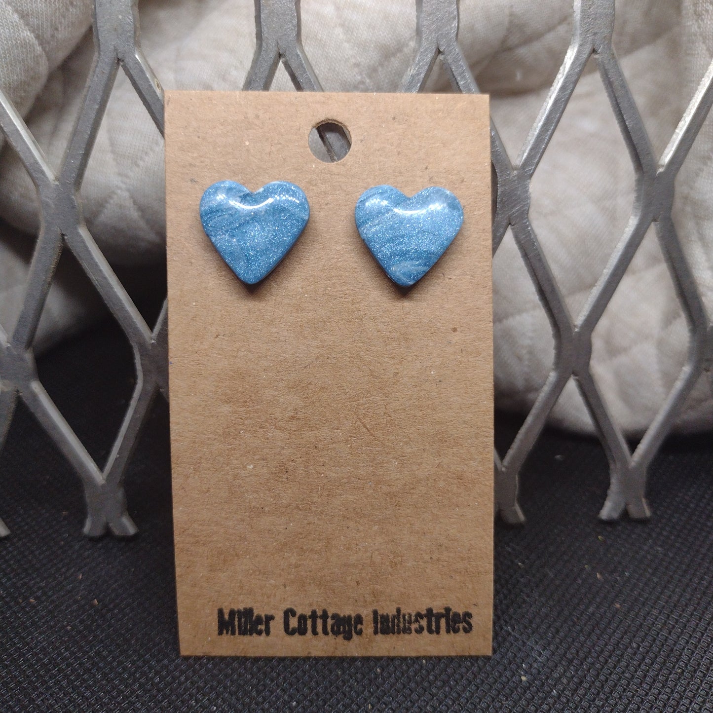 Blue and sparkling swirls heart studs