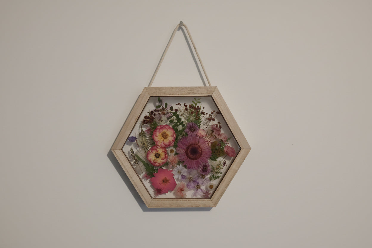 Pink pressed flowers in a hexagon