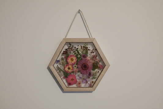 Pink pressed flowers in a hexagon