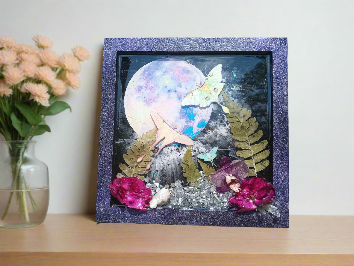 Moths flying in front of the moon