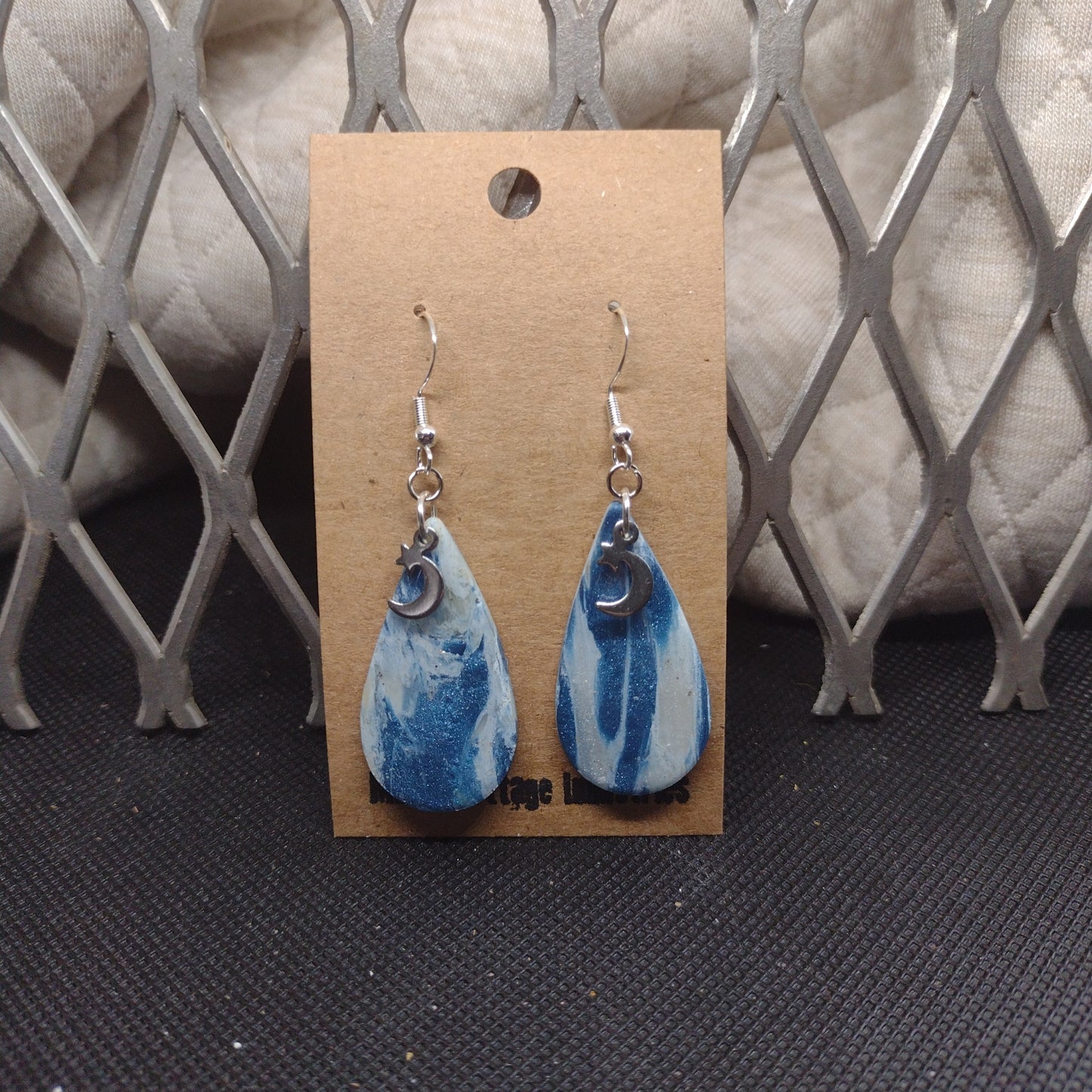 Blue and sparkly swirls with moon and star charms