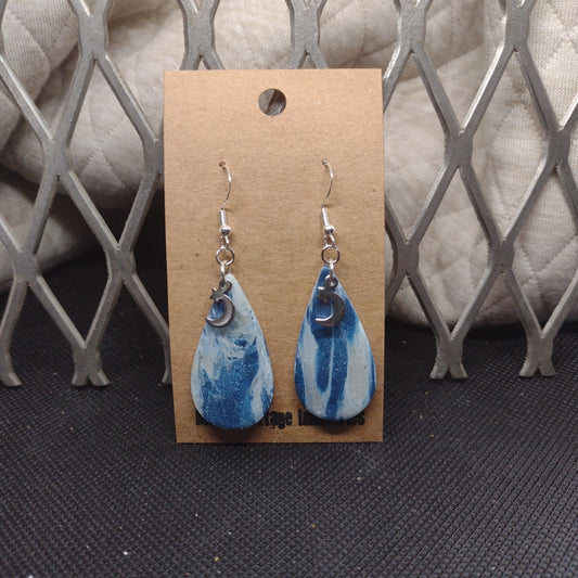 Blue and sparkly swirls with moon and star charms