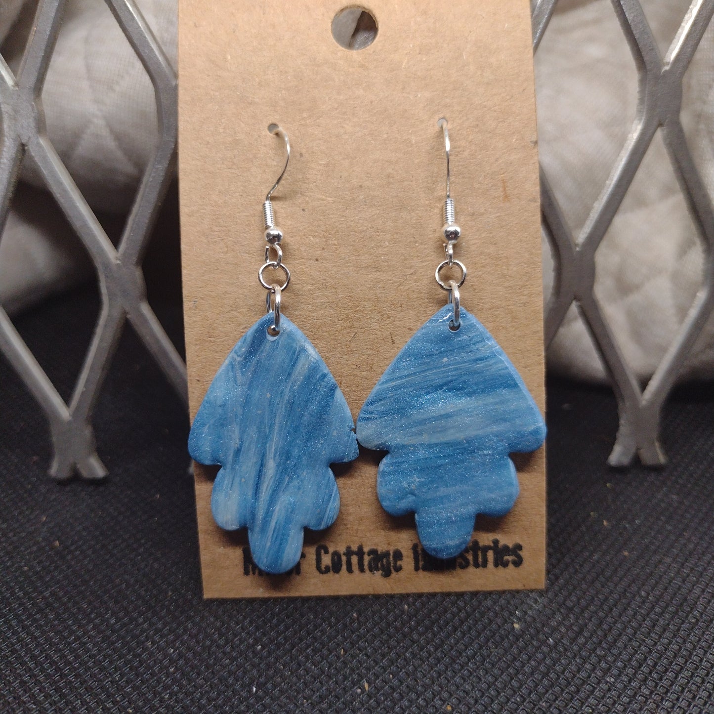 Blue and sparkling swirls fan in silver