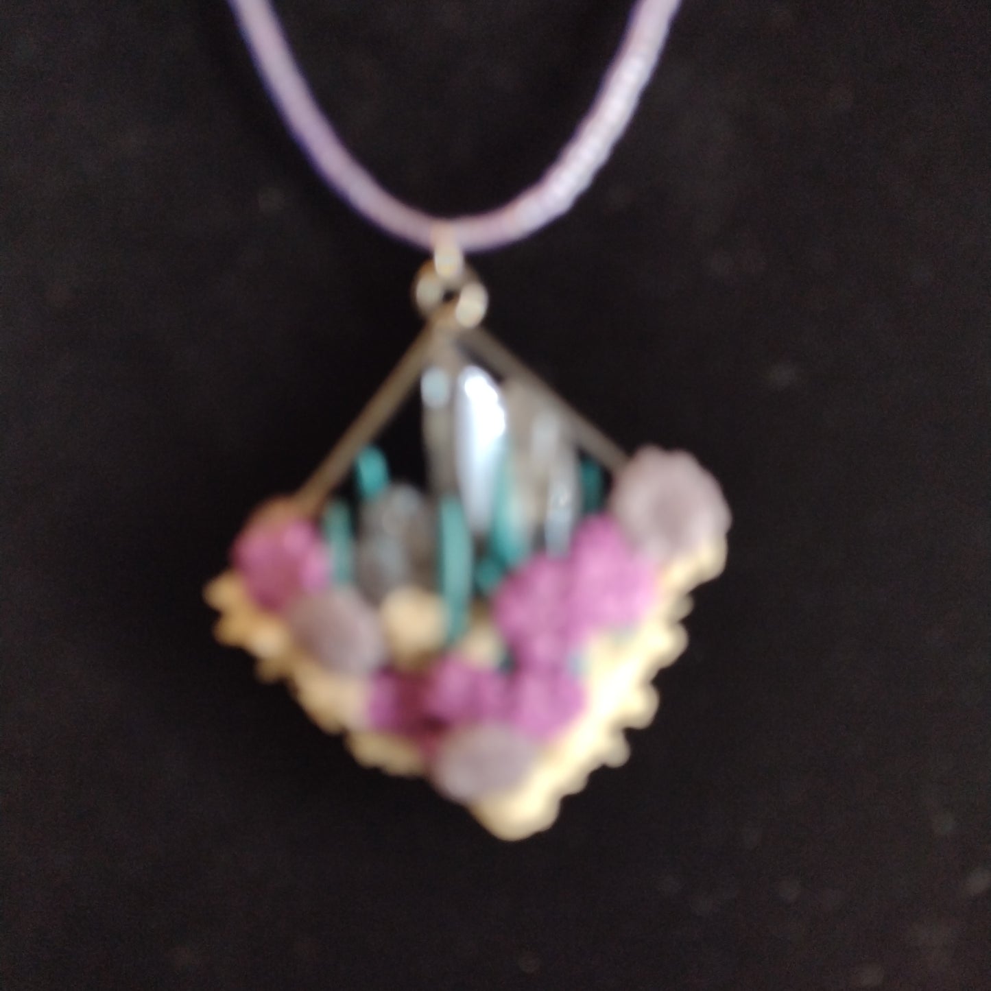 Crystals and glow-in-the-dark pendant on purple seed bead necklace. Matching stud earrings